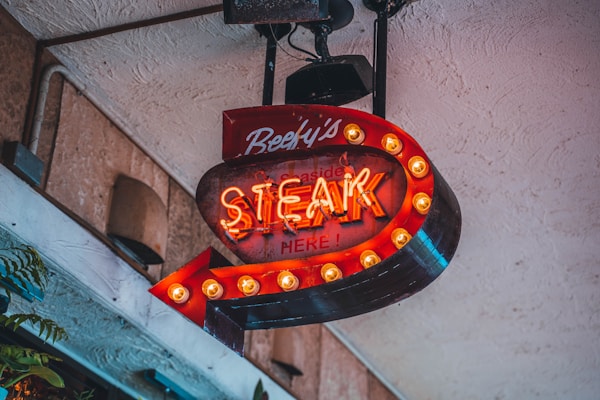 Neon logo of a steak restaurant in Okinawa, Japan.
